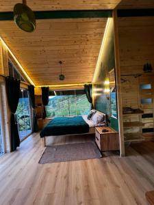 a bedroom with a bed in a tiny house at Файна хата 4 in Synevyrsʼka Polyana