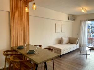 a living room with a table and a couch at Apartment in central Palermo, BsAs, full amenities in Buenos Aires +33 photos