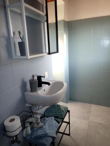 a bathroom with a sink and a mirror at Cute house in San Nicolò