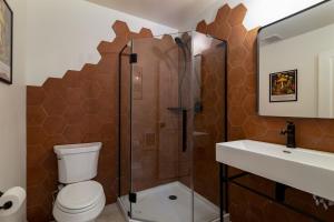 a bathroom with a toilet and a shower and a sink at Cozy Zion Retreat Hot Tub 2 King Bedrooms in Orderville +18 photos