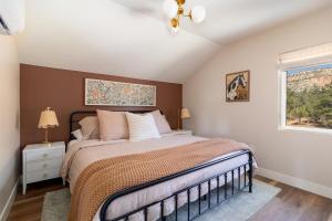 a bedroom with a large bed and a window at Cozy Zion Retreat Hot Tub 2 King Bedrooms in Orderville