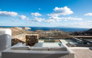 a view of the ocean from the balcony of a house at Amallini Suites Mykonos in Super Paradise Beach +154 photos
