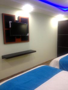 Postel nebo postele na pokoji v ubytování Hotel de las Américas - Ambato
