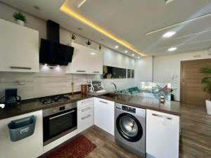 a kitchen with a washer and a dishwasher at RÉSIDENCE LA TERRASSE s2 AVEC BALCON & TERRASSE "Only Family" in Hammamet