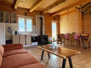 a living room with a couch and a table at Mountain Peace Cottage in Žabljak