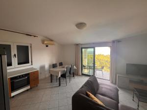 a living room with a couch and a table at Apartment Milat in Seget Donji