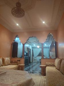 a bedroom with two beds and a large mirror at Mogadorista pour les familles in Essaouira +5 photos