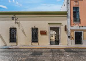 a building with two gates on a street at Hotel Boutique La Casona by Kavia in Mérida +41 photos