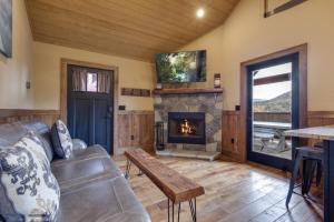 a living room with a couch and a fireplace at Lost Horizon by Venture Smoky Mountains in Sevierville