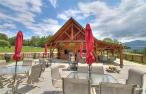 a patio with tables and chairs and a wooden pavilion at Lost Horizon by Venture Smoky Mountains in Sevierville