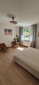 a bedroom with a large bed and a window at Apartament LUA in Ustka