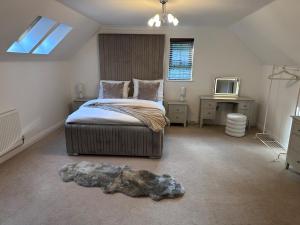 ein Schlafzimmer mit einem Bett mit einem Stein auf dem Boden in der Unterkunft Elegant 5 Bed 5 Bath Home in Englefield Green