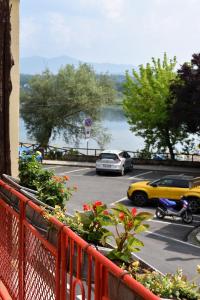 a balcony with a view of a parking lot with cars at Ninfa Del Lago Bedrooms by Dinamica Real Estate in Posta Fibreno