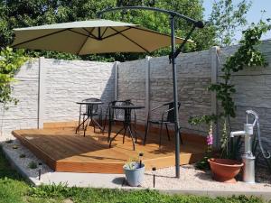 a patio with a table and an umbrella at Zlatno 66 in Zlaté Moravce