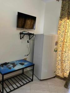 a room with a table next to a refrigerator at White Bay Ras Sedr وايت باي راس سدر in Ras Sedr +4 photos