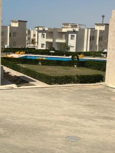 a view of a swimming pool with buildings in the background at White Bay Ras Sedr وايت باي راس سدر in Ras Sedr