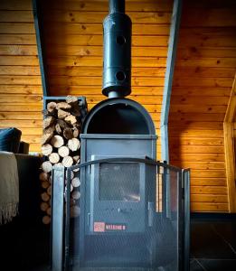 a wood stove with a tv in a room at M Cabin A Frame Predeal Ciubar in Predeal