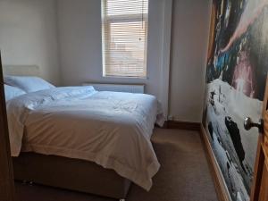 a bedroom with a bed and a window at Decent Rooms in Wakefield in Wakefield