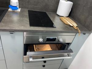 a kitchen with an oven with a pan in it at The 4 Suns Apartment in Benalmádena +8 photos
