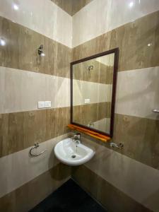 a bathroom with a sink and a mirror at Oasis Bay - Arugam Bay in Arugam Bay