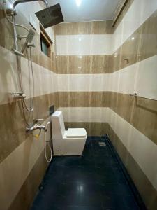 a bathroom with a toilet and a shower at Oasis Bay - Arugam Bay in Arugam Bay