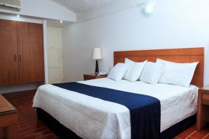 Postel nebo postele na pokoji v ubytování Hotel Calli