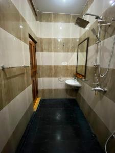 a bathroom with a sink and a mirror at Oasis Bay - Arugam Bay in Arugam Bay