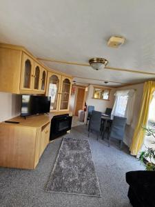 an rv living room with a television and a table at Skye Holiday Caravan 6 in Uig