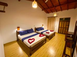 a bedroom with two beds with hearts on them at Oasis Bay - Arugam Bay in Arugam Bay