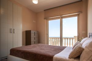 Postel nebo postele na pokoji v ubytování Seaside Villa Margarita