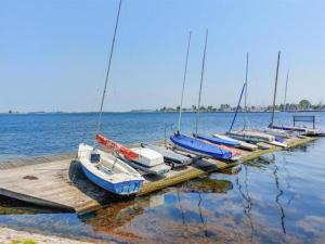 a group of boats docked at a dock in the water at Holiday Home in Zeeland Family-Friendly in Serooskerke