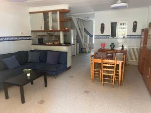 a living room with a blue couch and a table at La mar de bien in El Perelló