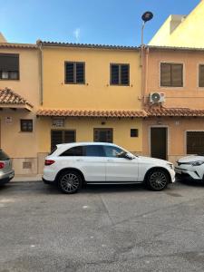 a white car parked in front of a building at La mar de bien in El Perelló