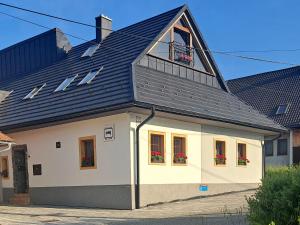 ein großes weißes Haus mit einem Walmdach in der Unterkunft Privat LeNa in Ružomberok