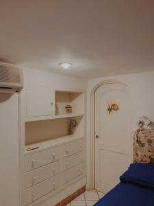 a bedroom with a bed and a closet with drawers at Pied-à-Terre in Piazzetta in Capri