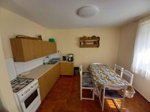 a kitchen with a table and a stove and a counter top at Holiday home in Badacsony - Balaton 18019 in Badacsony
