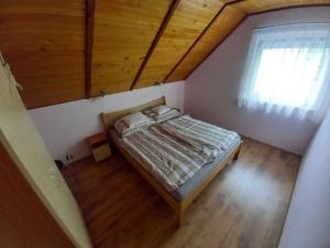 a small bedroom with a bed and a window at Holiday home in Badacsony - Balaton 18019 in Badacsony +20 photos