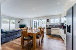 a kitchen and living room with a table and chairs at House with heated pool in Gujan-Mestras