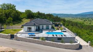 an aerial view of a house with a swimming pool at NEW! Villa Dalmatia with Sauna, Hot tub, Heated pool in Grubine