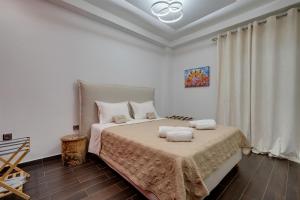 a bedroom with a bed with two towels on it at Aphrodites House Upon White Tower in Thessaloniki