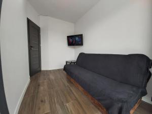 a living room with a couch and a door at 1140 Włościańska 5 - Tanie Pokoje w Apartamencie - samodzielne zameldowanie - self check in in Poznań