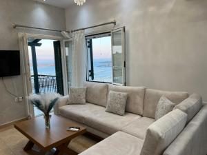 a living room with a couch and a table at Akadia Syros in Ermoupoli