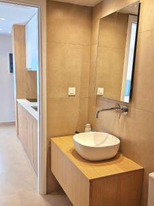 a bathroom with a bowl sink and a mirror at NAMI Seaside in Kokkini Khanion