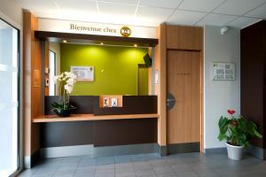 a hospital lobby with a sign that reads discharge clerk at B&B HOTEL Lyon Eurexpo Chassieu in Chassieu