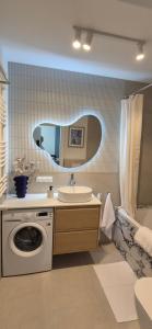 a bathroom with a sink and a washing machine at Pino 46 Sobieszewo Gdańsk in Gdańsk +18 photos