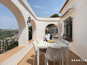 a white table and chairs on a balcony at VH CostaBlanca - RULLE in Benissa