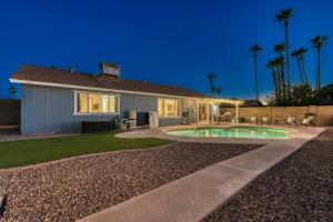 a house with a swimming pool in the yard at Tranquility 4 Bedroom With Free Heated Pool! in Mesa