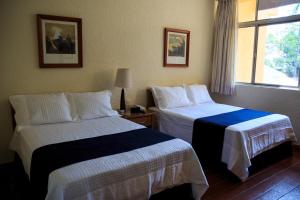 Postel nebo postele na pokoji v ubytování Hotel Calli