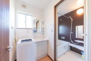 a bathroom with a sink and a tub and a toilet at Private House Fuji - Vacation STAY 74689v in Azagawa +23 photos
