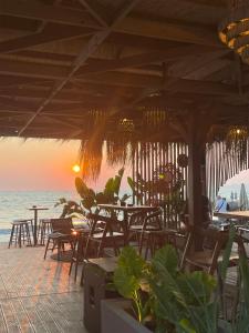 a restaurant with tables and chairs on the beach at Relax apartment, Side Sea View, Golem, Albania in Golem